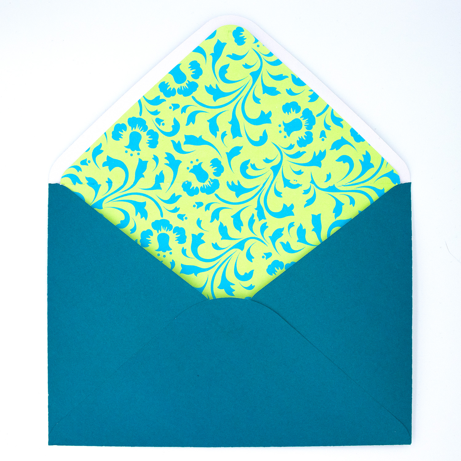 5x7 handmade envelope by Clikchic Designs in teal with a decorative floral liner in yellow and aqua, shown open with flap up.