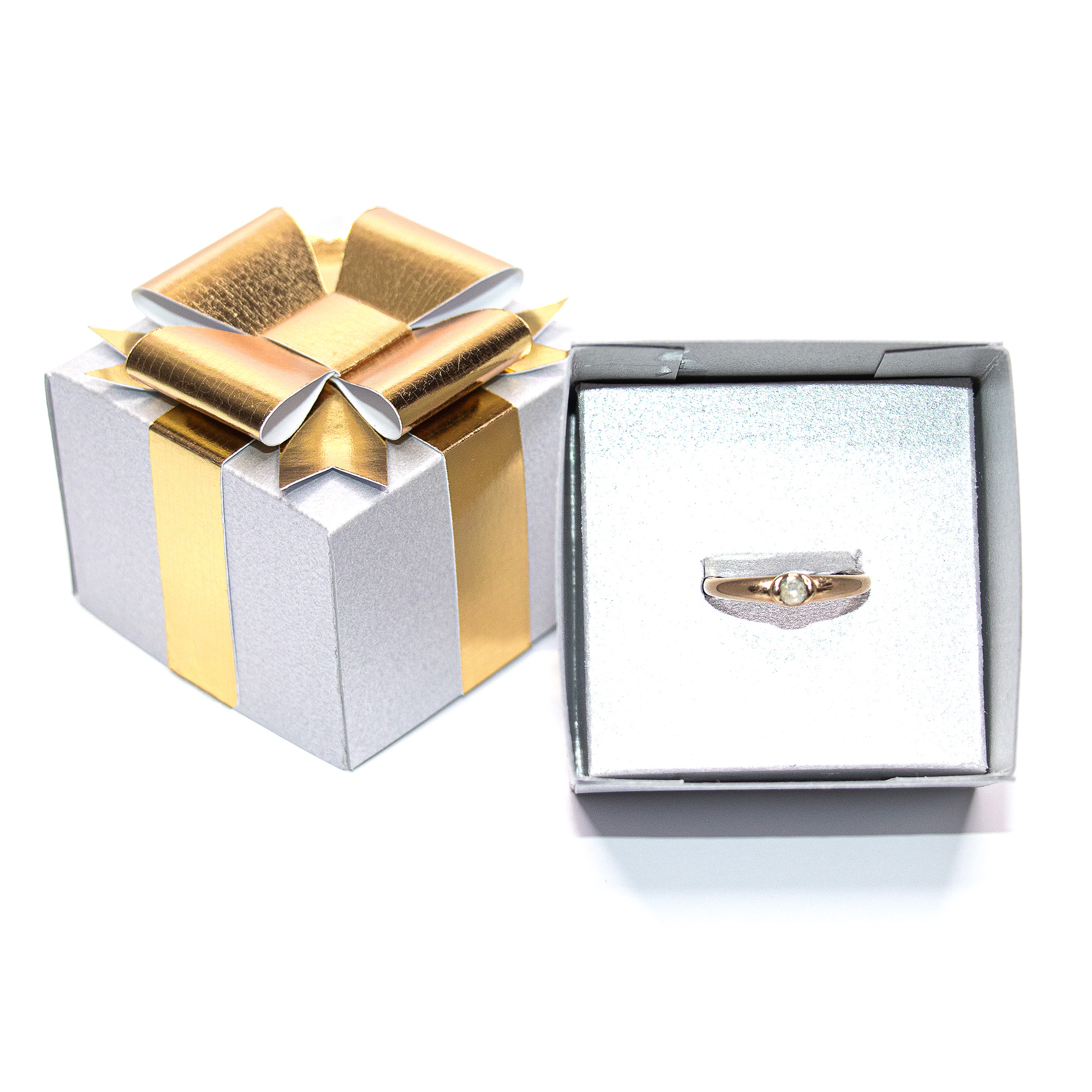 Silver textured cardstock 3D jewelry gift box with a gold paper ribbon and layered bow, shown closed, open with red crystal drop earrings on a white insert, open with a gold ring on a ring insert, and beside a silver and gold metallic version, a jewelry packaging cut file for Silhouette Studio