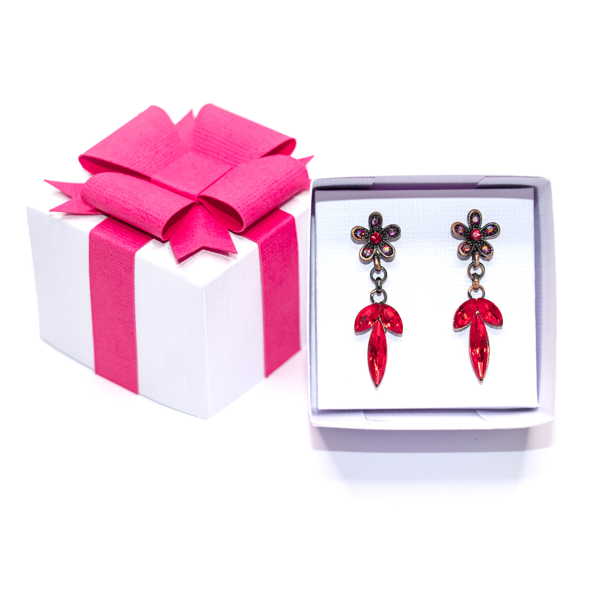White textured cardstock 3D jewelry gift box with a hot pink paper ribbon and layered bow, shown closed, open with red crystal drop earrings on a white insert, open with a gold ring on a ring insert, and beside a silver and gold metallic version, a jewelry packaging cut file for Silhouette Studio