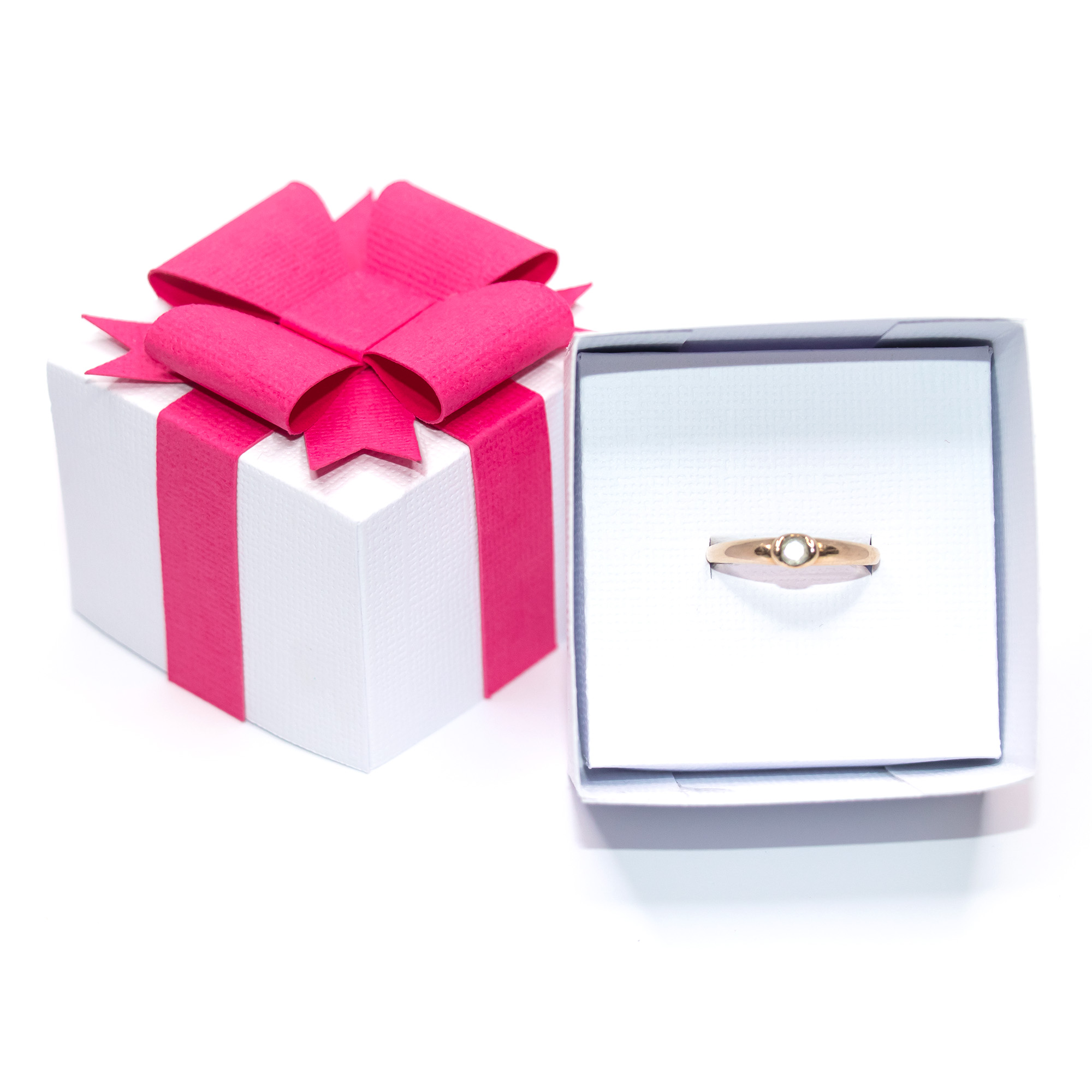 White textured cardstock 3D jewelry gift box with a hot pink paper ribbon and layered bow, shown closed, open with red crystal drop earrings on a white insert, open with a gold ring on a ring insert, and beside a silver and gold metallic version, a jewelry packaging cut file for Silhouette Studio