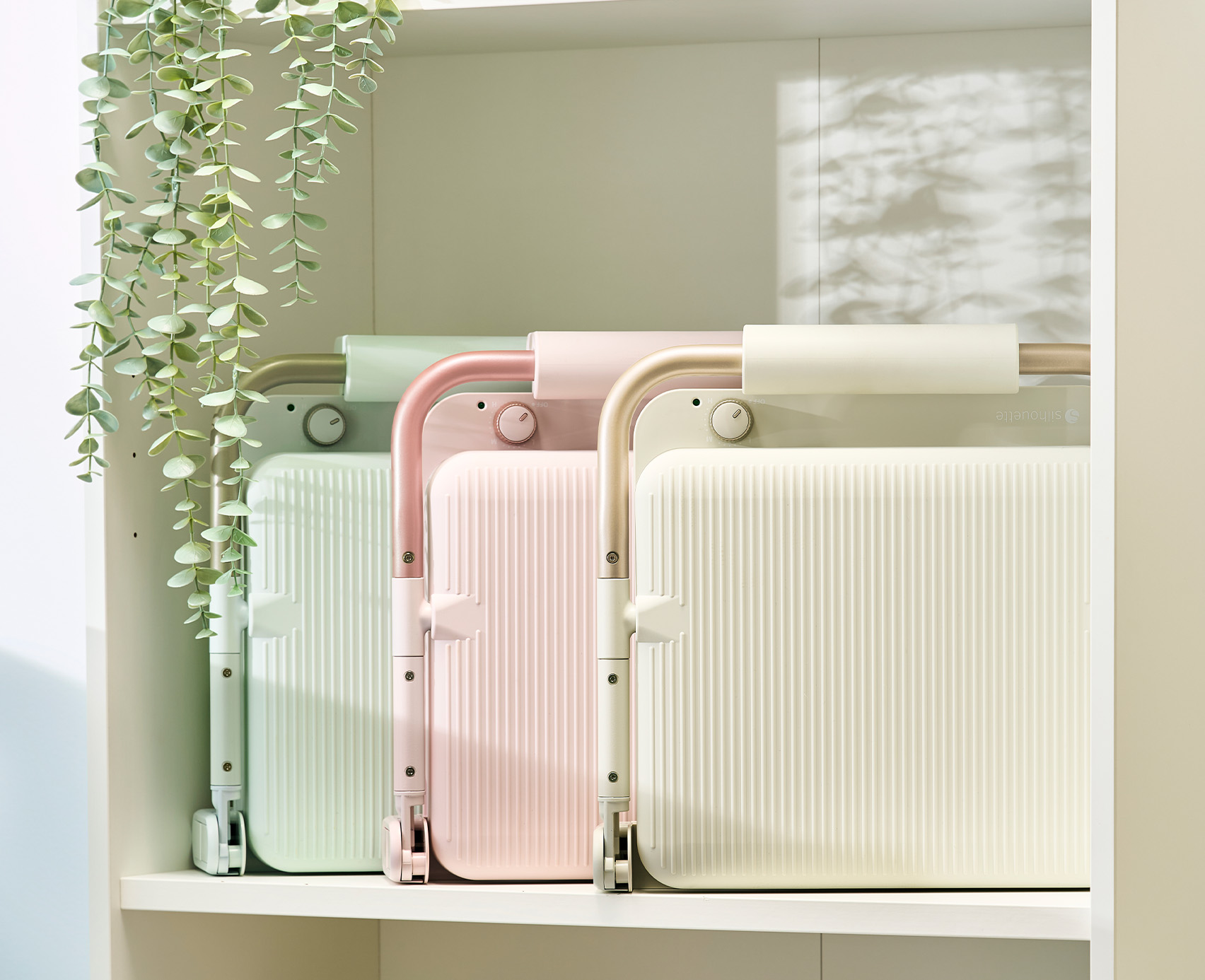 3 Silhouette cloChé Heat Presses lined up in a row on a bookshelf. 